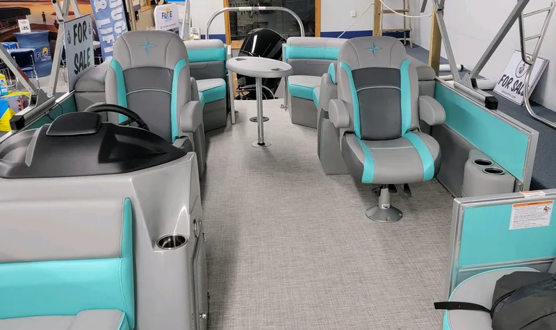 Slide: The Image of 2023 Berkshire 22 RFX CTS pontoon boat interior with teal and gray seating. - 4