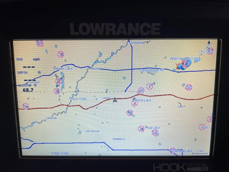 Slide: The Image of Lowrance Hook Reveal GPS display showing lake and creek navigation routes. - 8
