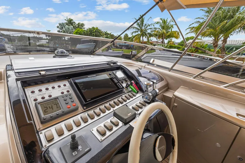 Slide: The Image of 2010 Riva Rama yacht cockpit with navigation controls and tropical background. - 10