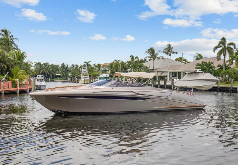 Slide: The Image of Riva Rama 2010 luxury yacht docked in a tropical marina with palm trees. - 6