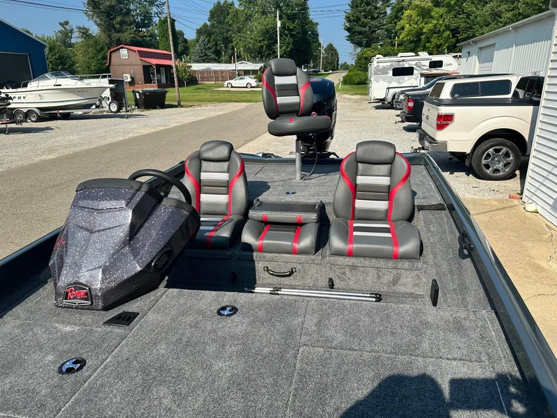 Slide: The Image of 2024 Ranger RT198P fishing boat with gray and red seats, parked outdoors. - 9