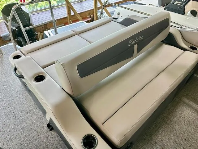 Slide: The Image of 2024 Barletta Cabrio 22UC boat interior with beige seating and cup holders. - 5