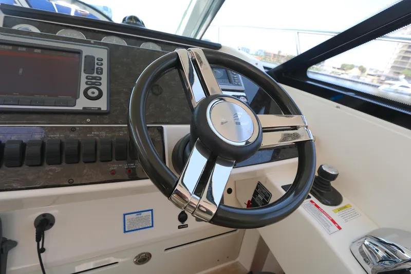 Slide: The Image of Steering wheel and dashboard of 2013 Sea Ray 410 Sundancer boat. - 10