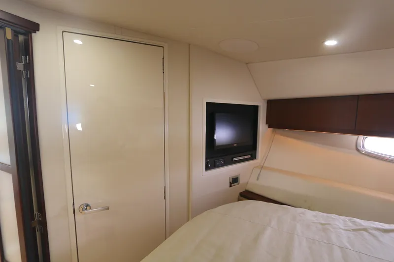 Slide: The Image of Interior cabin of 2013 Sea Ray 410 Sundancer with TV and bed. - 15