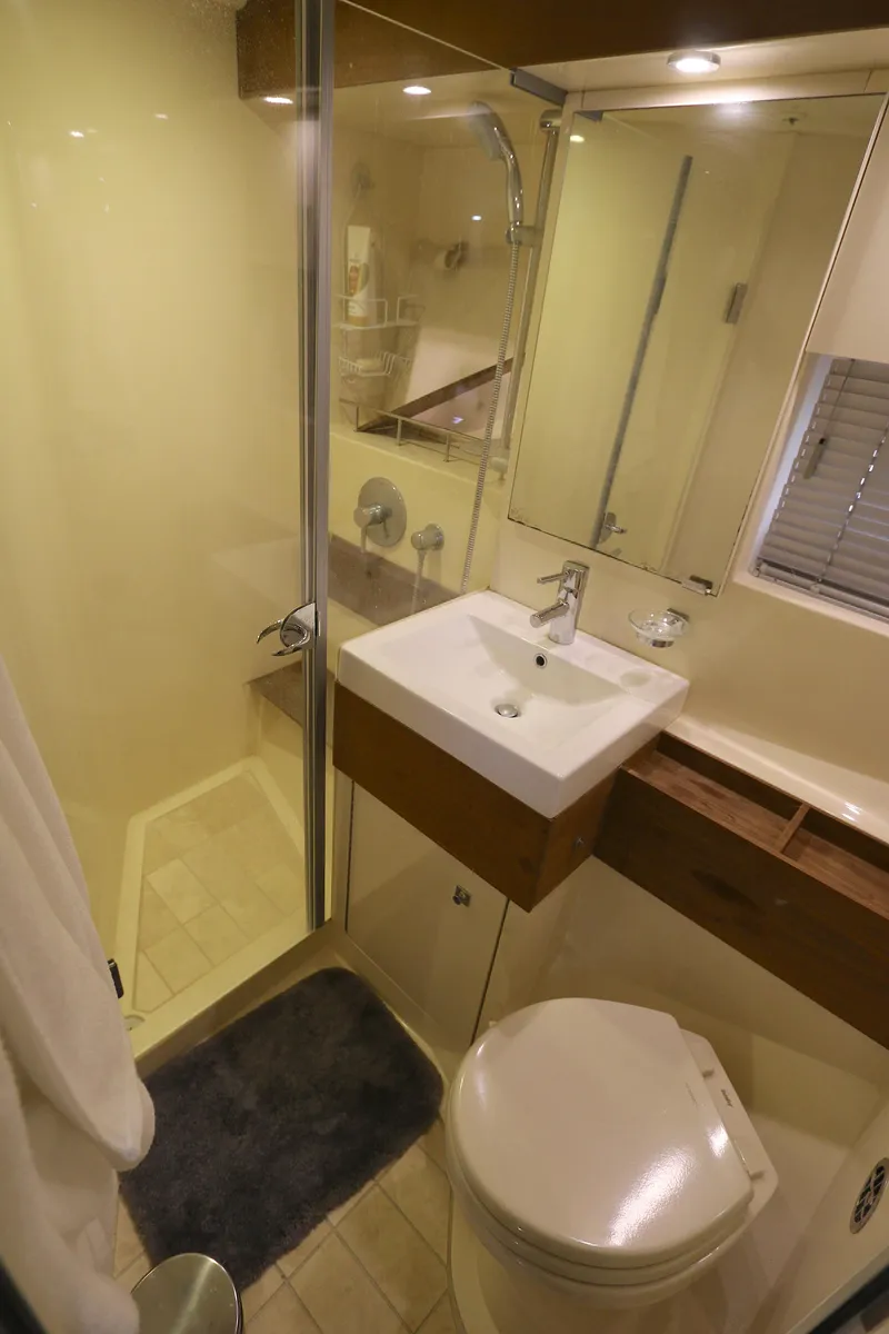 Slide: The Image of Bathroom interior of 2013 Sea Ray 410 Sundancer yacht with shower, sink, and toilet. - 16