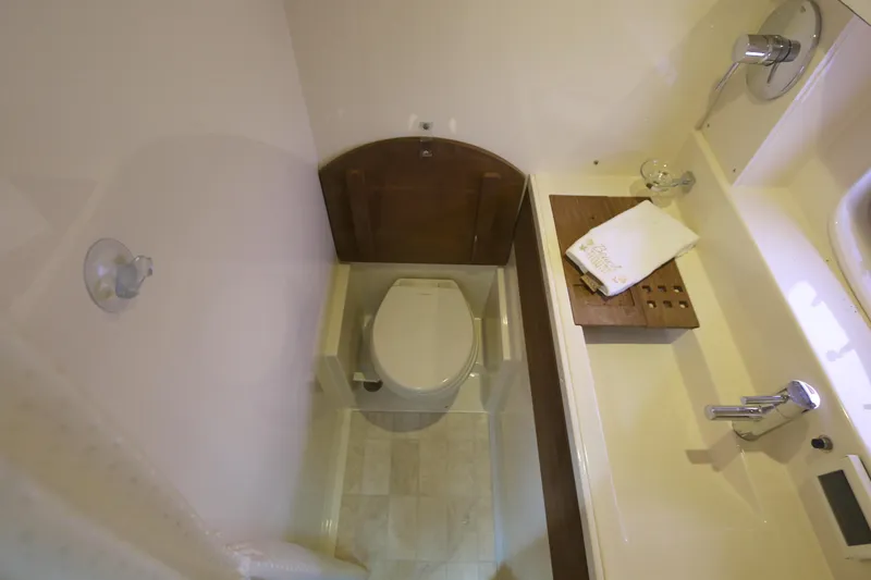 Slide: The Image of Bathroom interior of 2013 Sea Ray 410 Sundancer yacht, featuring toilet and sink. - 17
