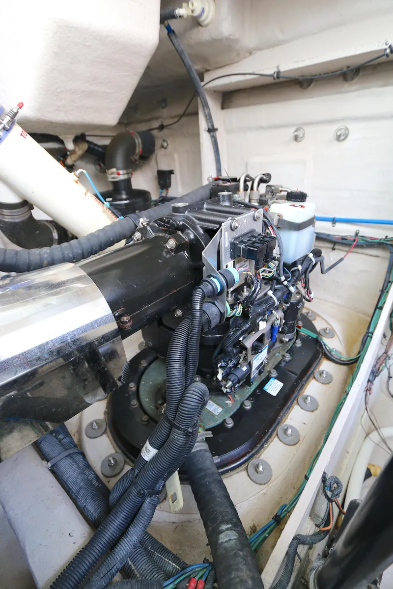 Slide: The Image of Engine compartment of 2013 Sea Ray 410 Sundancer, showcasing mechanical components and wiring. - 23