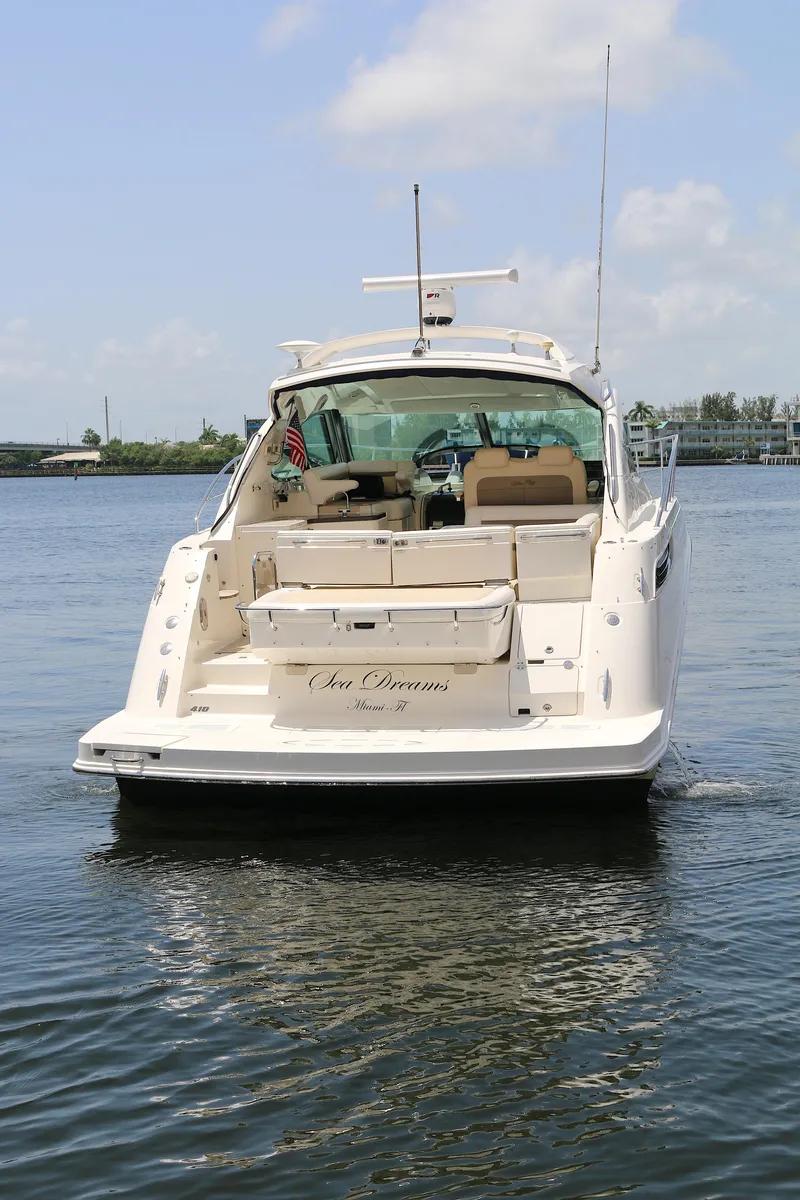 Slide: The Image of 2013 Sea Ray 410 Sundancer yacht on calm water, rear view. - 25
