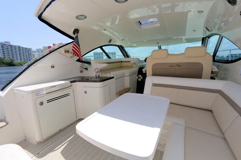 Slide: The Image of Interior of 2013 Sea Ray 410 Sundancer yacht with seating and kitchenette. - 6