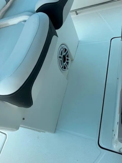 Slide: The Image of 2024 Robalo 270 CC boat interior with cushioned seating and speaker detail. - 10