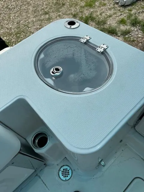 Slide: The Image of 2024 Robalo 270 CC livewell with clear lid and secure latches. - 13