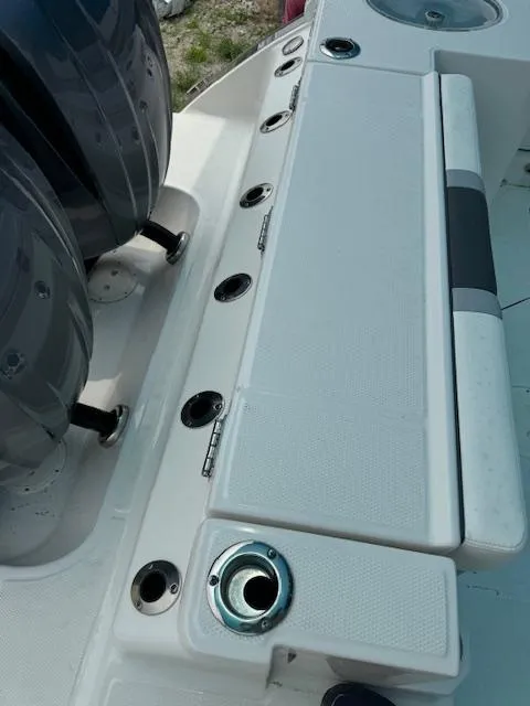 Slide: The Image of 2024 Robalo 270 CC boat deck with seating and rod holders. - 15
