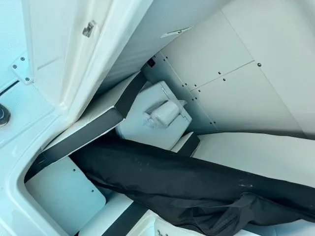 Slide: The Image of 2024 Robalo 270 CC interior storage compartment with seating and equipment. - 16