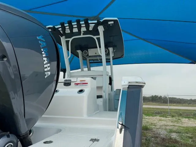 Slide: The Image of 2024 Robalo 270 CC boat with Yamaha engine under blue canopy. - 6