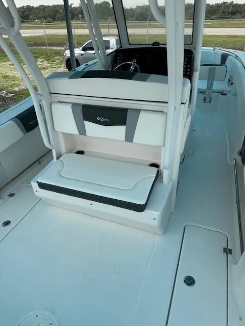 Slide: The Image of 2024 Robalo 270 CC boat interior with seating and helm station. - 7