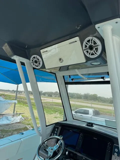 Slide: The Image of 2024 Robalo 270 CC boat interior with steering wheel and electronics. - 8