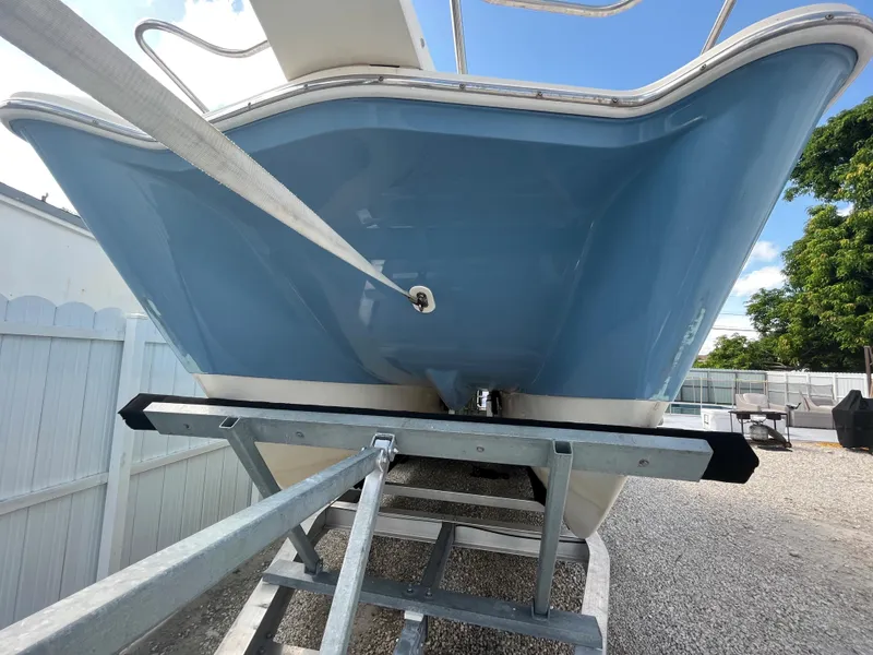 Slide: The Image of 2004 World Cat 270 SF boat on trailer, blue hull, rear view. - 10
