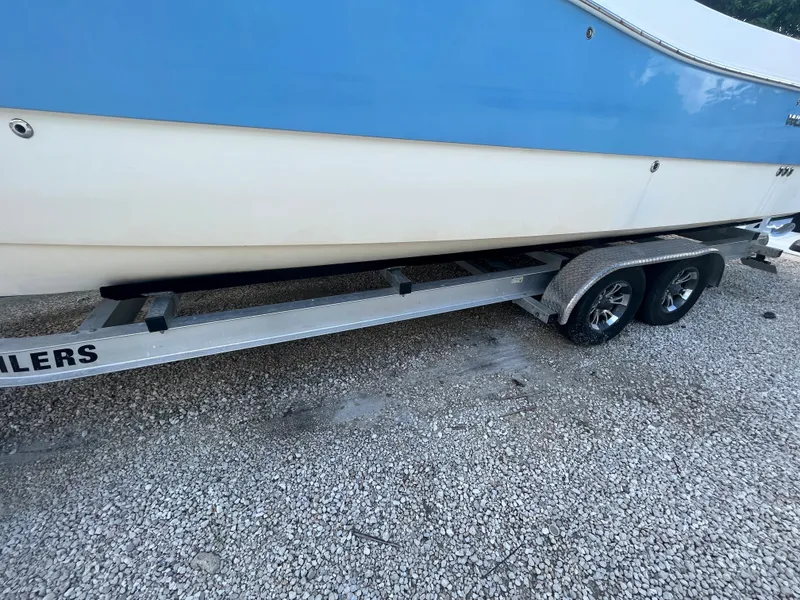 Slide: The Image of 2004 World Cat 270 SF boat on a dual-axle trailer. - 13