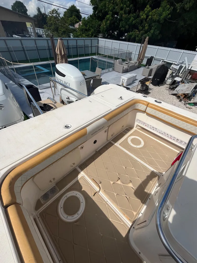 Slide: The Image of 2004 World Cat 270 SF boat deck with seating and storage compartments. - 24