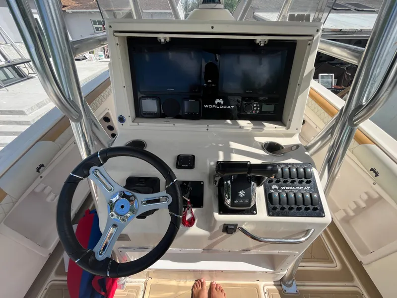 Slide: The Image of 2004 World Cat 270 SF boat helm with steering wheel and control panel. - 29
