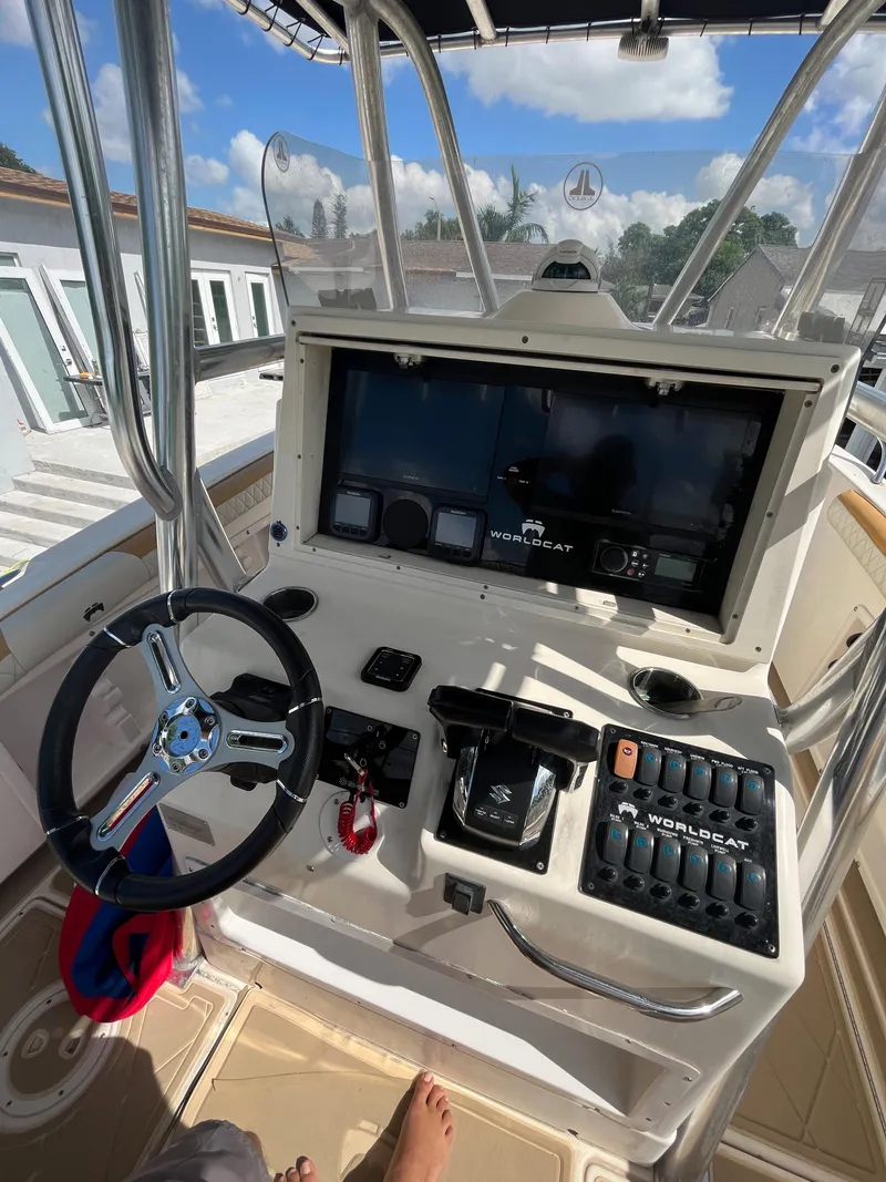 Slide: The Image of Helm of a 2004 World Cat 270 SF boat with steering wheel and control panel. - 30