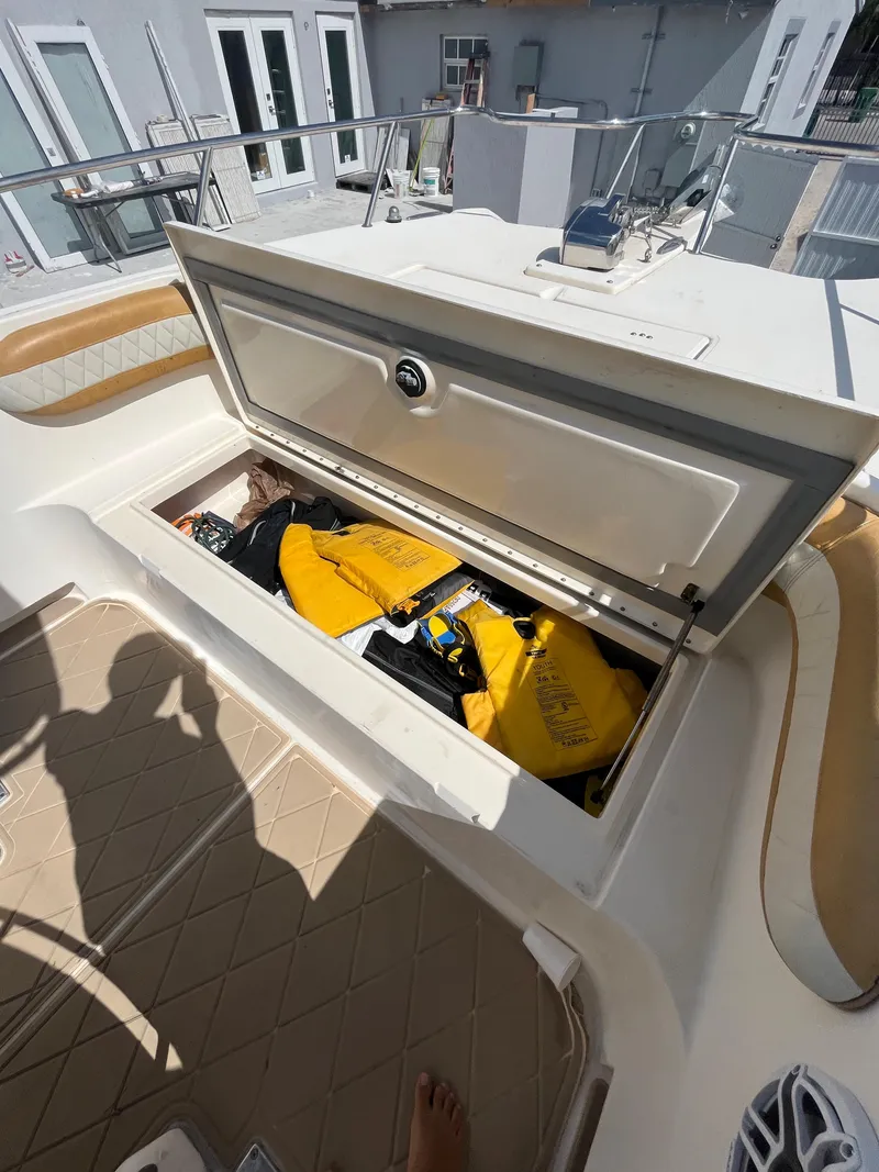 Slide: The Image of 2004 World Cat 270 SF boat storage compartment with life jackets. - 33