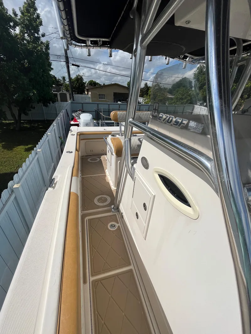 Slide: The Image of 2004 World Cat 270 SF boat deck with cushioned seating and storage compartments. - 38