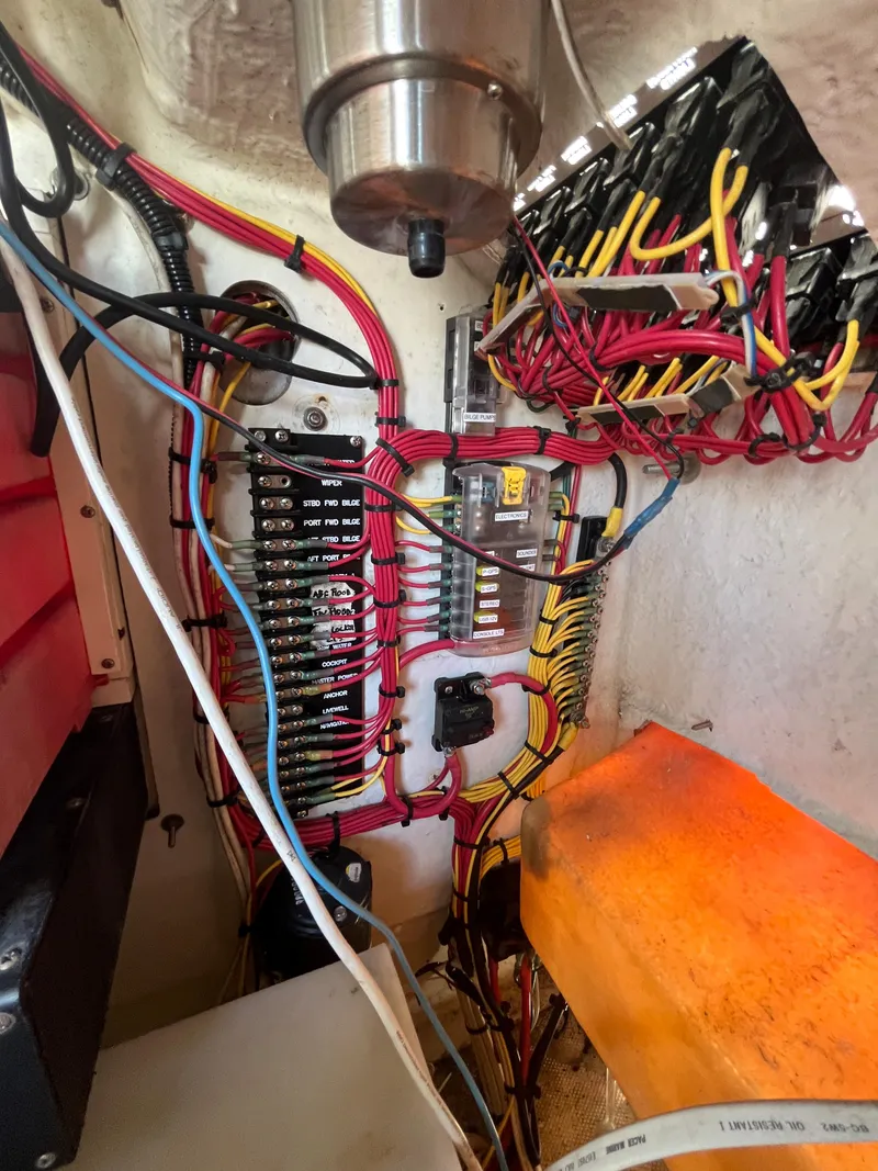 Slide: The Image of Electrical wiring and fuse panel inside a 2004 World Cat 270 SF boat. - 41