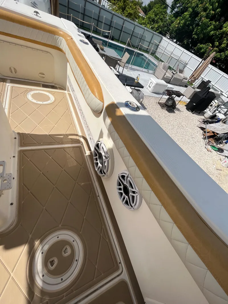 Slide: The Image of 2004 World Cat 270 SF boat interior with tan and white upholstery. - 48