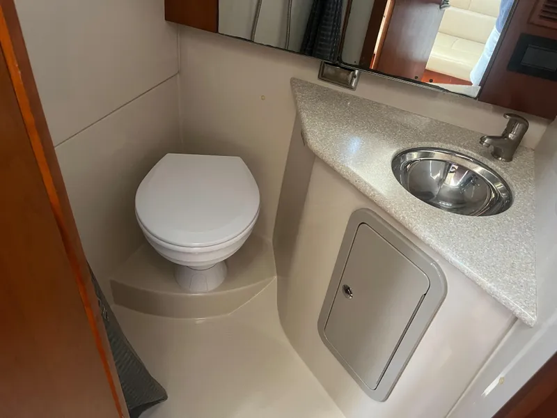 Slide: The Image of 2008 Rampage 30 Express boat bathroom with toilet, sink, and storage cabinet. - 21