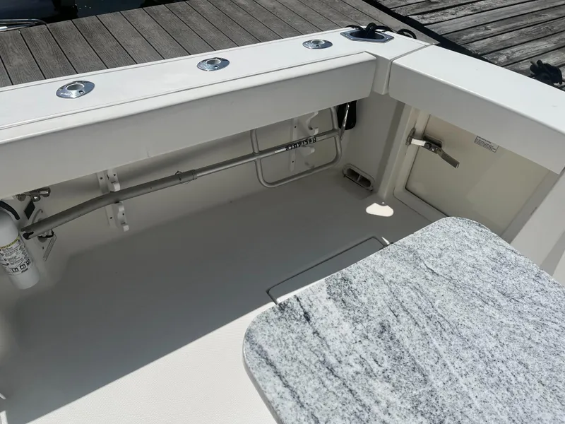 Slide: The Image of 2008 Rampage 30 Express boat interior with granite table and clean deck. - 25