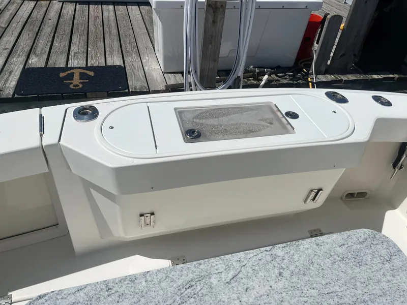 Slide: The Image of 2008 Rampage 30 Express boat deck with storage compartments and fishing rod holders. - 27