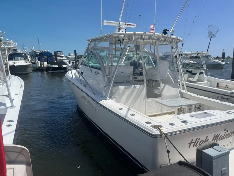 Slide: The Image of 2008 Rampage 30 Express boat docked in marina under clear blue sky. - 3