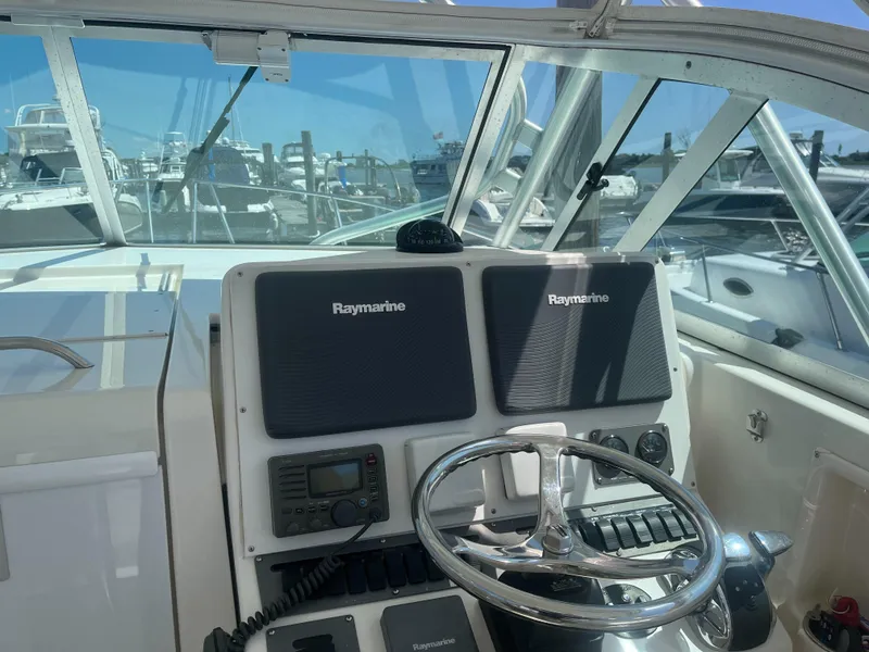 Slide: The Image of 2008 Rampage 30 Express boat helm with Raymarine navigation system. - 30