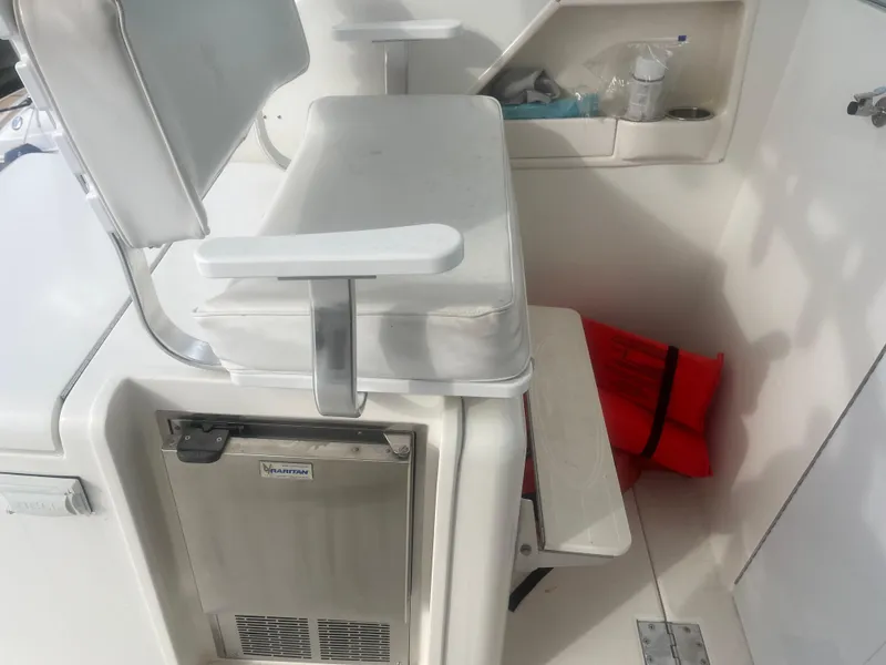 Slide: The Image of 2008 Rampage 30 Express boat interior with seat, mini fridge, and life jacket. - 34
