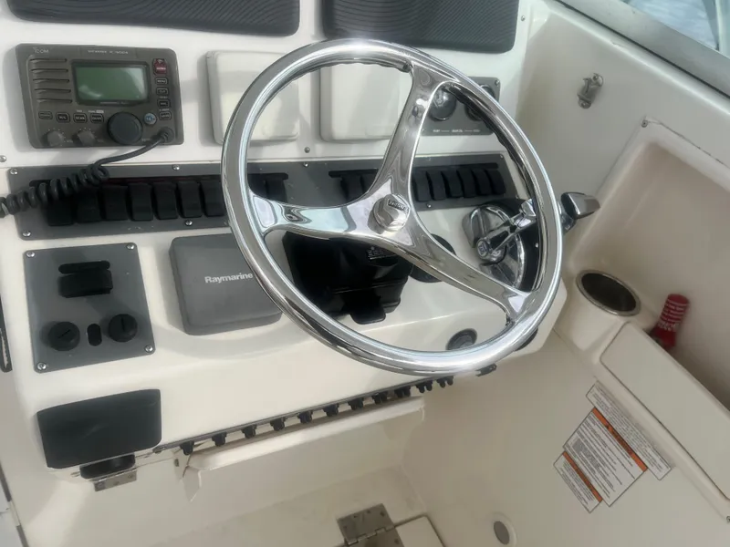 Slide: The Image of 2008 Rampage 30 Express boat helm with steering wheel and control panel. - 36