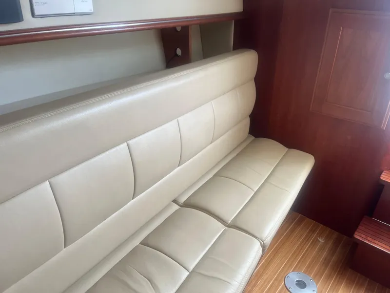 Slide: The Image of 2008 Rampage 30 Express interior with beige leather seating and wooden flooring. - 40