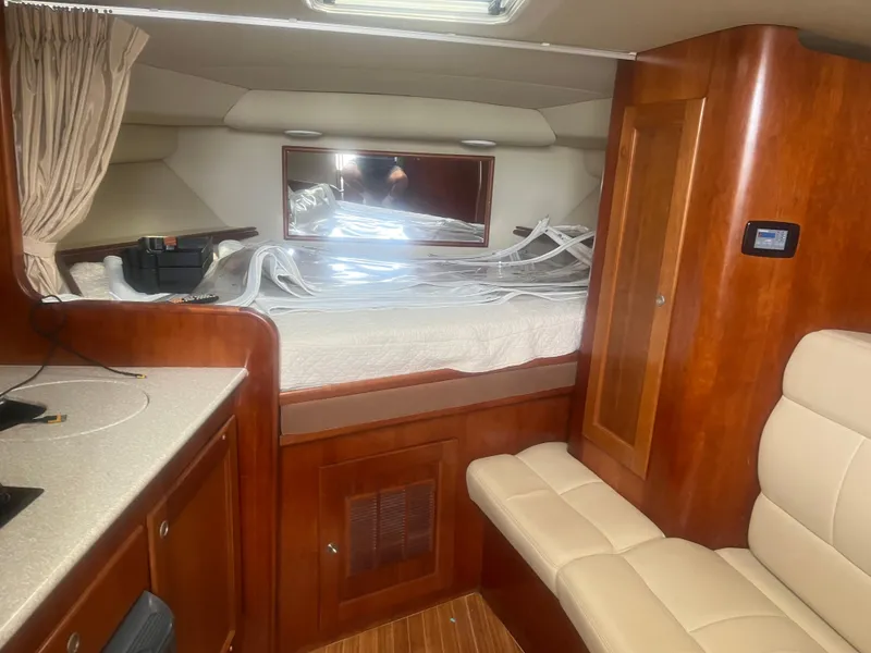 Slide: The Image of 2008 Rampage 30 Express cabin interior with bed, seating, and wood finish. - 42