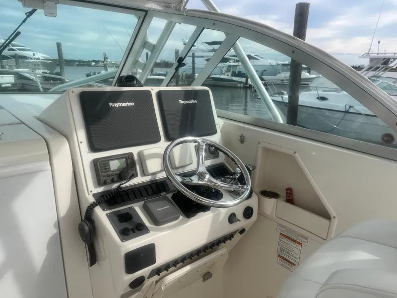 Slide: The Image of 2008 Rampage 30 Express boat helm with Raymarine electronics, docked in marina. - 44