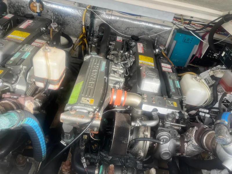 Slide: The Image of Engine compartment of a 2008 Rampage 30 Express boat, showcasing dual engines. - 46