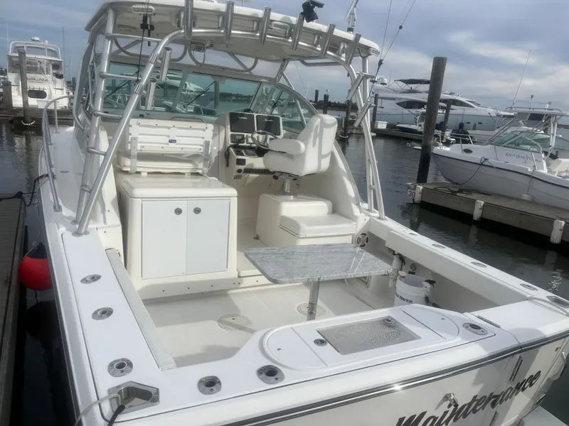 Slide: The Image of 2008 Rampage 30 Express boat docked at marina, featuring spacious cockpit and helm area. - 47
