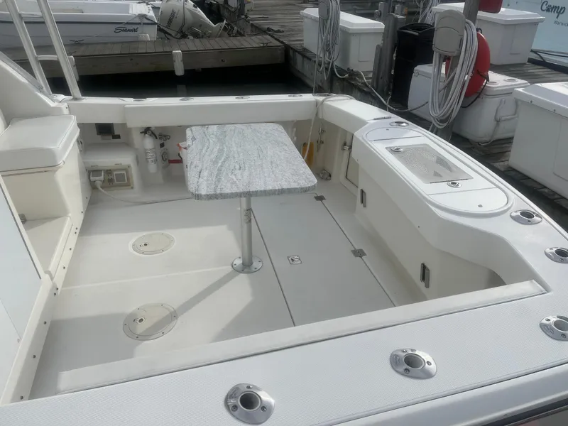 Slide: The Image of 2008 Rampage 30 Express boat deck with table and seating area. - 48