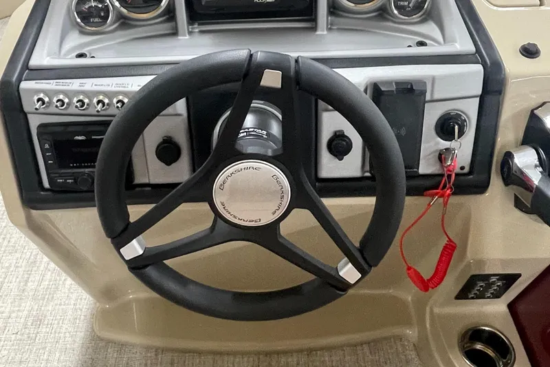 Slide: The Image of Steering wheel and dashboard of a 2023 Berkshire 22CL CTS boat. - 11