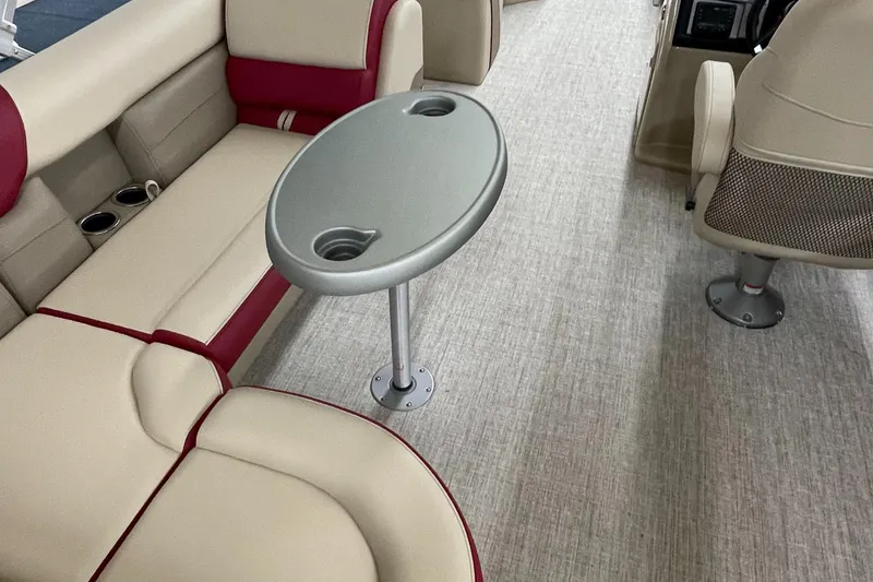 Slide: The Image of 2023 Berkshire 22CL CTS boat interior with beige and red seating, and a central table. - 8