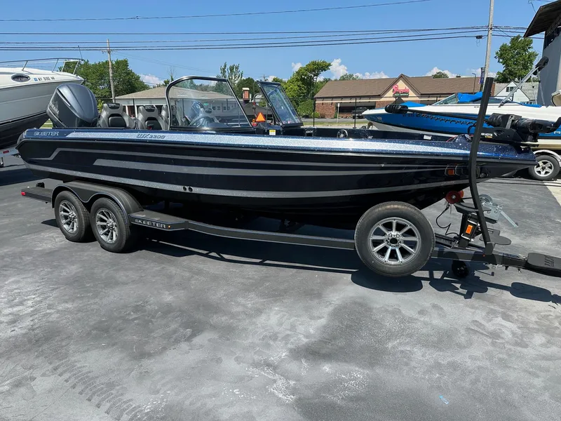 Slide: The Image of 2025 Skeeter WX2200 boat on trailer, parked outdoors under clear sky. - 3
