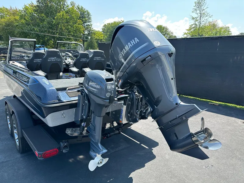Slide: The Image of 2025 Skeeter WX2200 boat with dual Yamaha outboard motors, parked outdoors. - 4