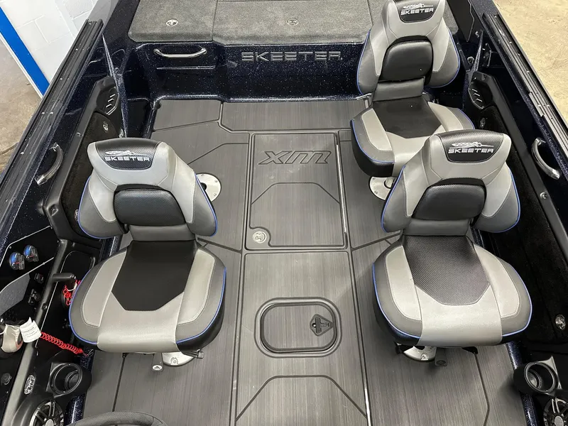 Slide: The Image of 2025 Skeeter WX2200 boat interior with four gray and black seats. - 6