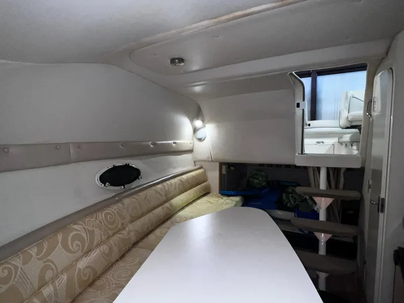 Slide: The Image of Interior cabin of a 2001 Larson 270 boat with seating and table. - 13