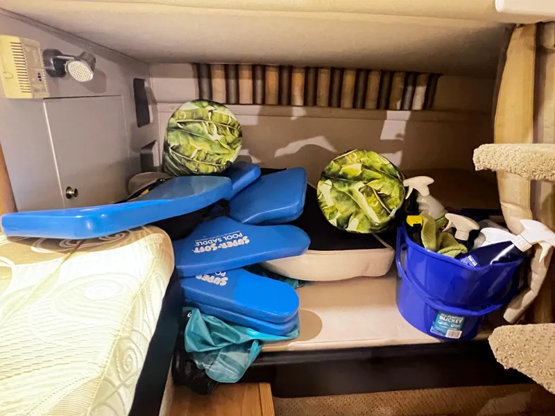 Slide: The Image of Interior storage area of a 2001 Larson 270 boat with various items. - 19