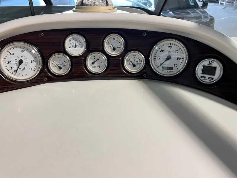 Slide: The Image of Dashboard of a 2001 Larson 270 boat with various gauges and instruments. - 21
